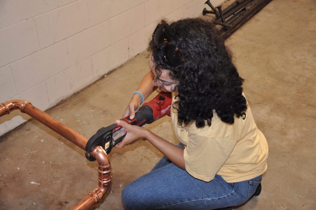Plumber soldering copper pipe fittings