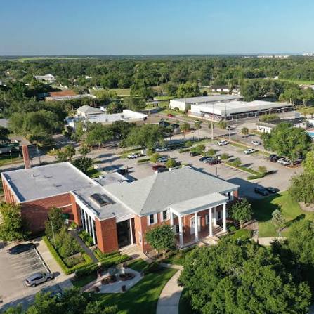 Aerial view of a brick building with white columns in Apopka, FL