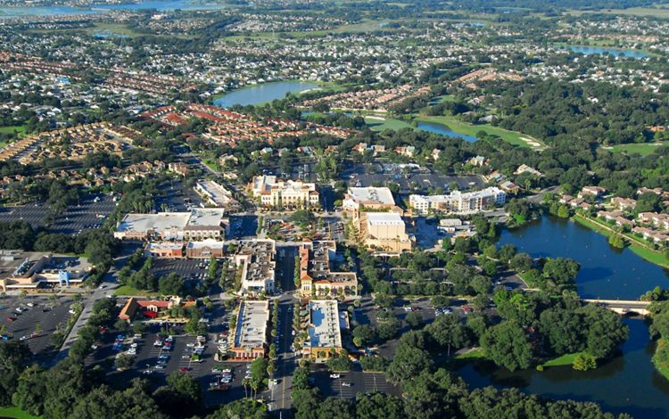 Aerial view of a lakeside town center and neighborhoods in Osceola County, FL