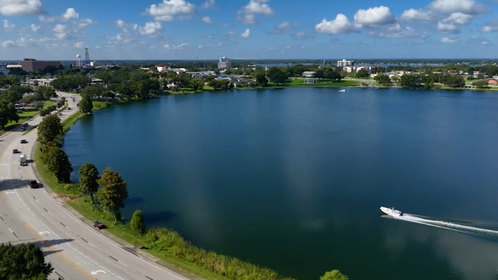 Aerial view of Winter Haven, FL, with a lake and lakeshore road