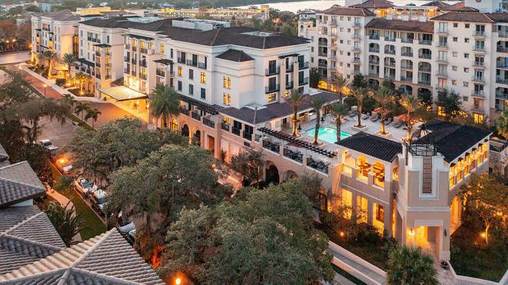 Aerial view of Mediterranean-style buildings lit at dusk in Winter Park, FL